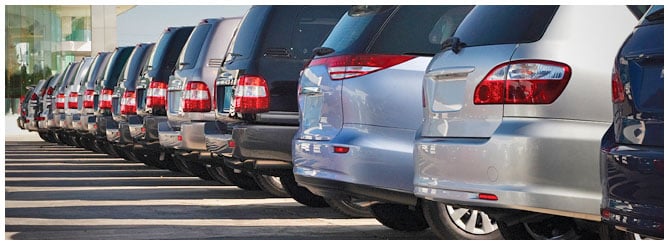 Row of cars on a large lot Row of cars on a large lot