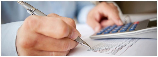 Image of a man working on reports Image of a man working on reports